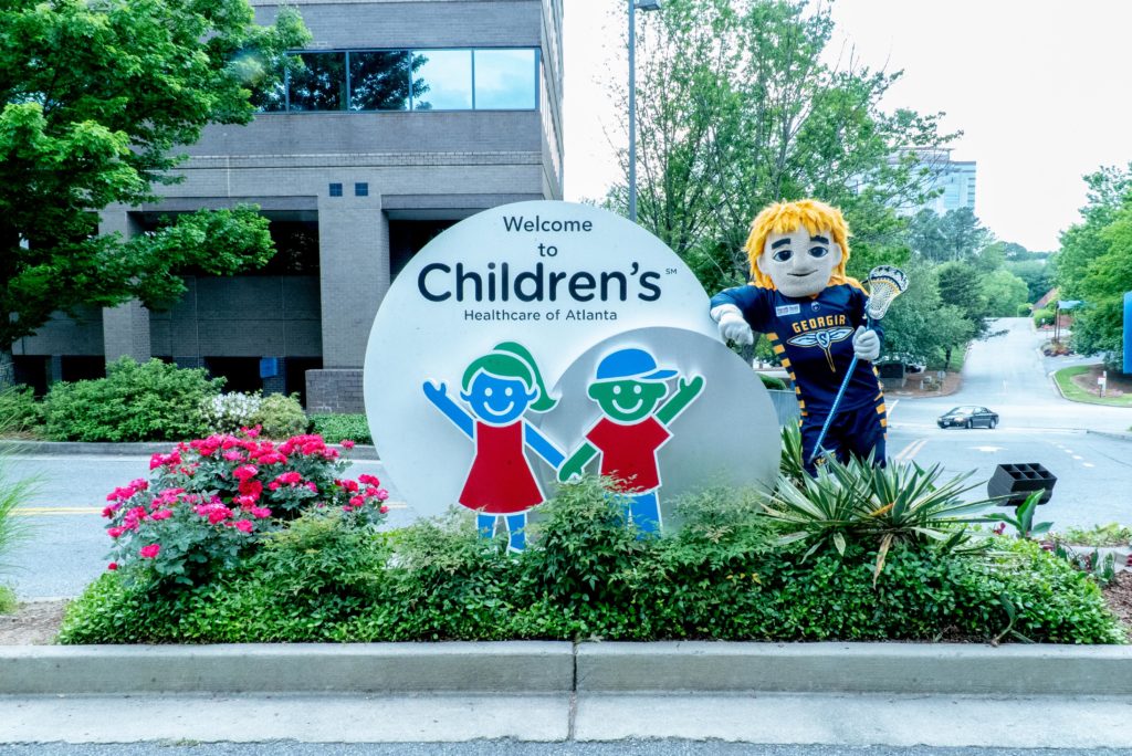 Picture of Georgia Swarm mascot next to Children's Healthcare of Atlanta sign